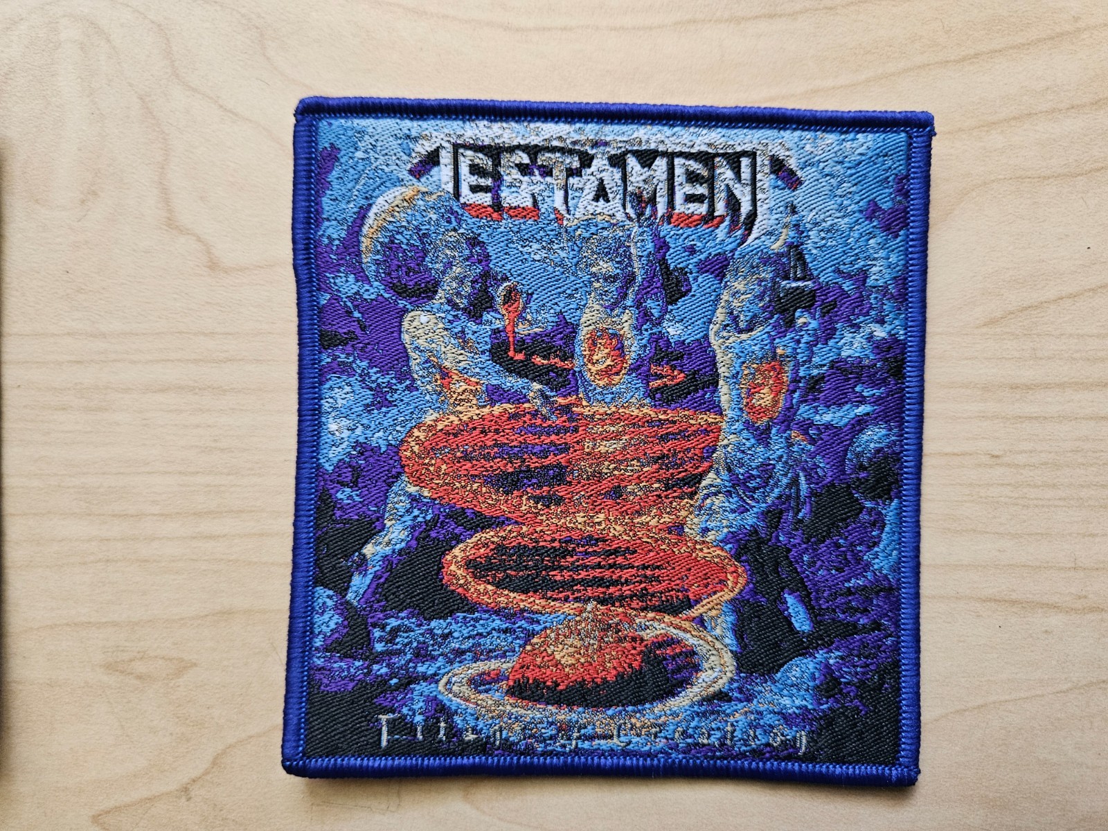 TESTAMENT, TITANS OF CREATION, SEW ON BLUE BORDER WOVEN PATCH