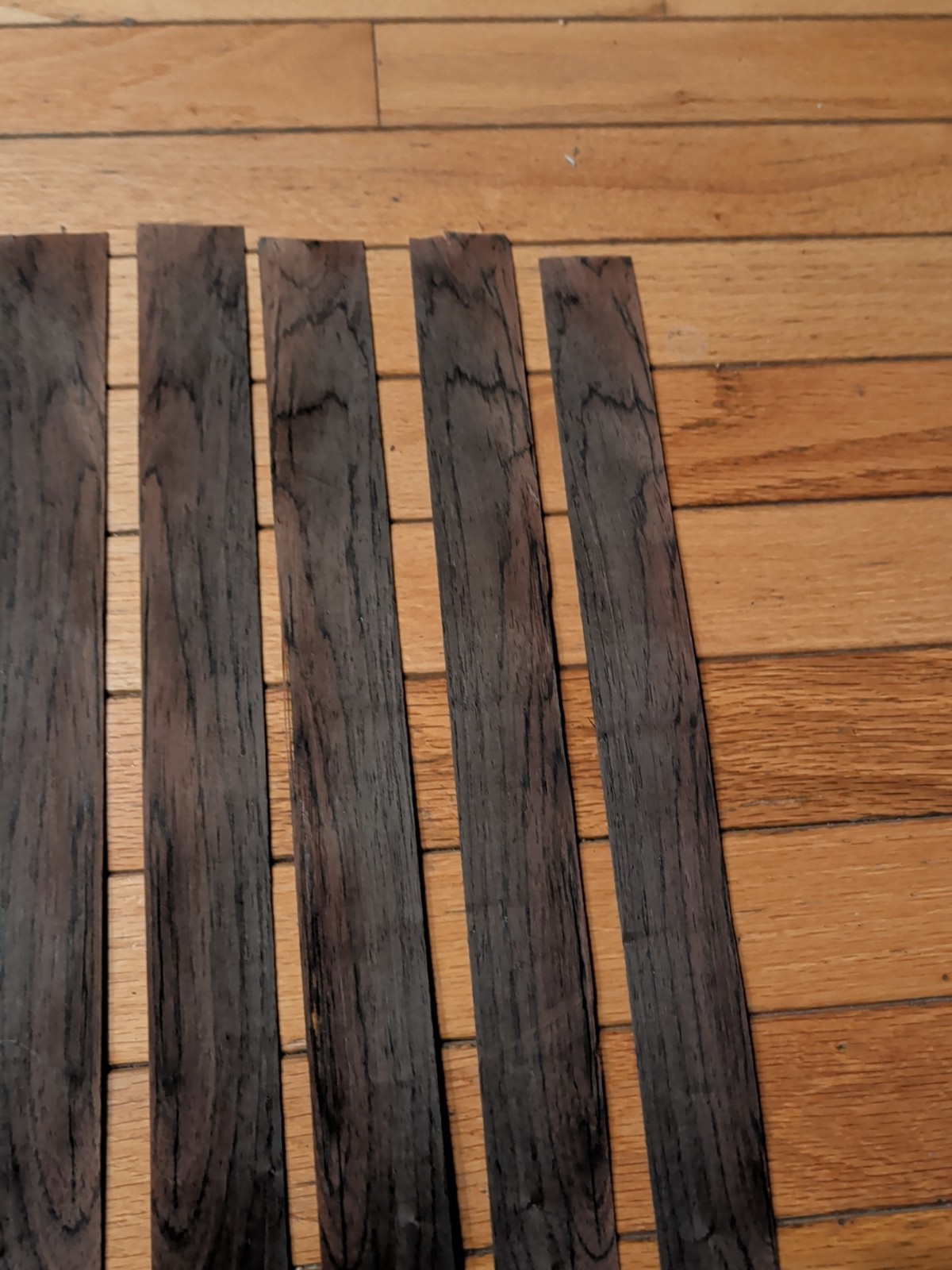 7 pieces of rosewood veneer 1 1/4" to 1 1/2" x 24 1/2" each raw 1/42"