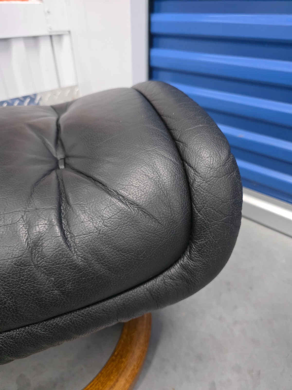 Ekornes Stressless Black Colored Leather Ottoman | Teak Stained Wood Base