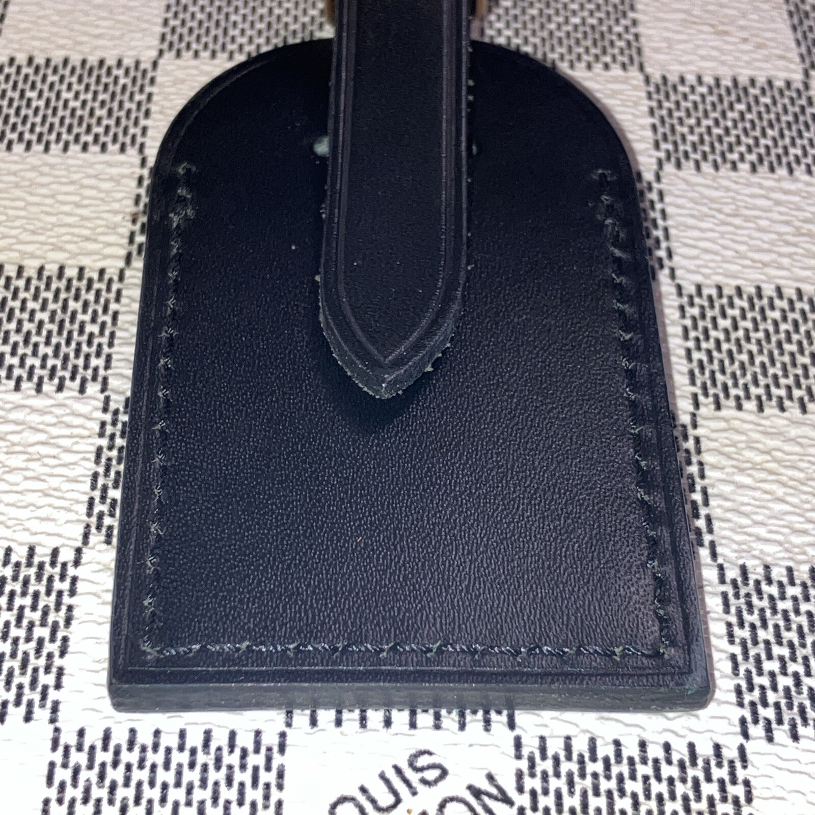 Authentic Louis Vuitton small Black W/ Gold Hardware name tag.