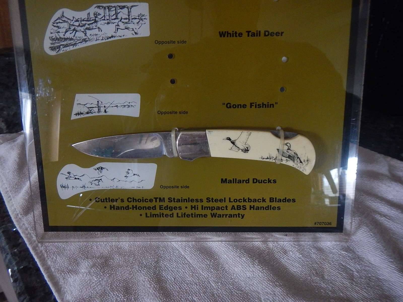 Vintage Sabre scrimshaw knife counter top store display with one NOS knife