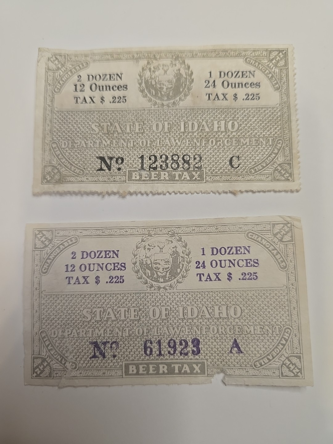 Back of book Lot . States Of Idaho Dept. Of Law Enforcement. Tax Stamps. (2)