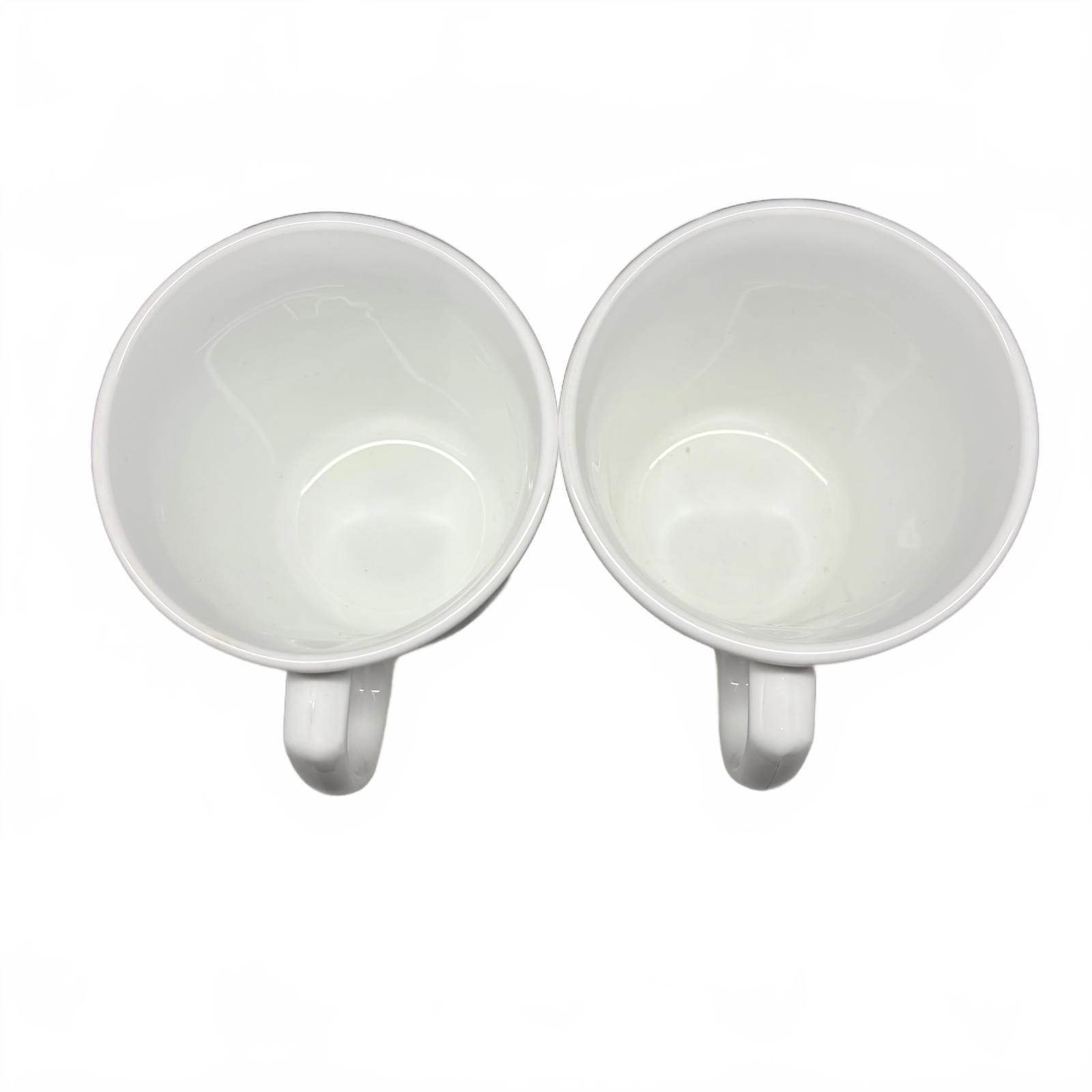 Two white Corning Ware Old Town Blue ceramic mugs with blue floral border.