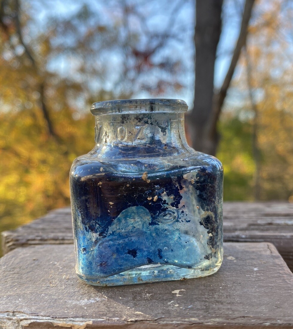 Clear Inkwell With Blue Ink And Partial Label