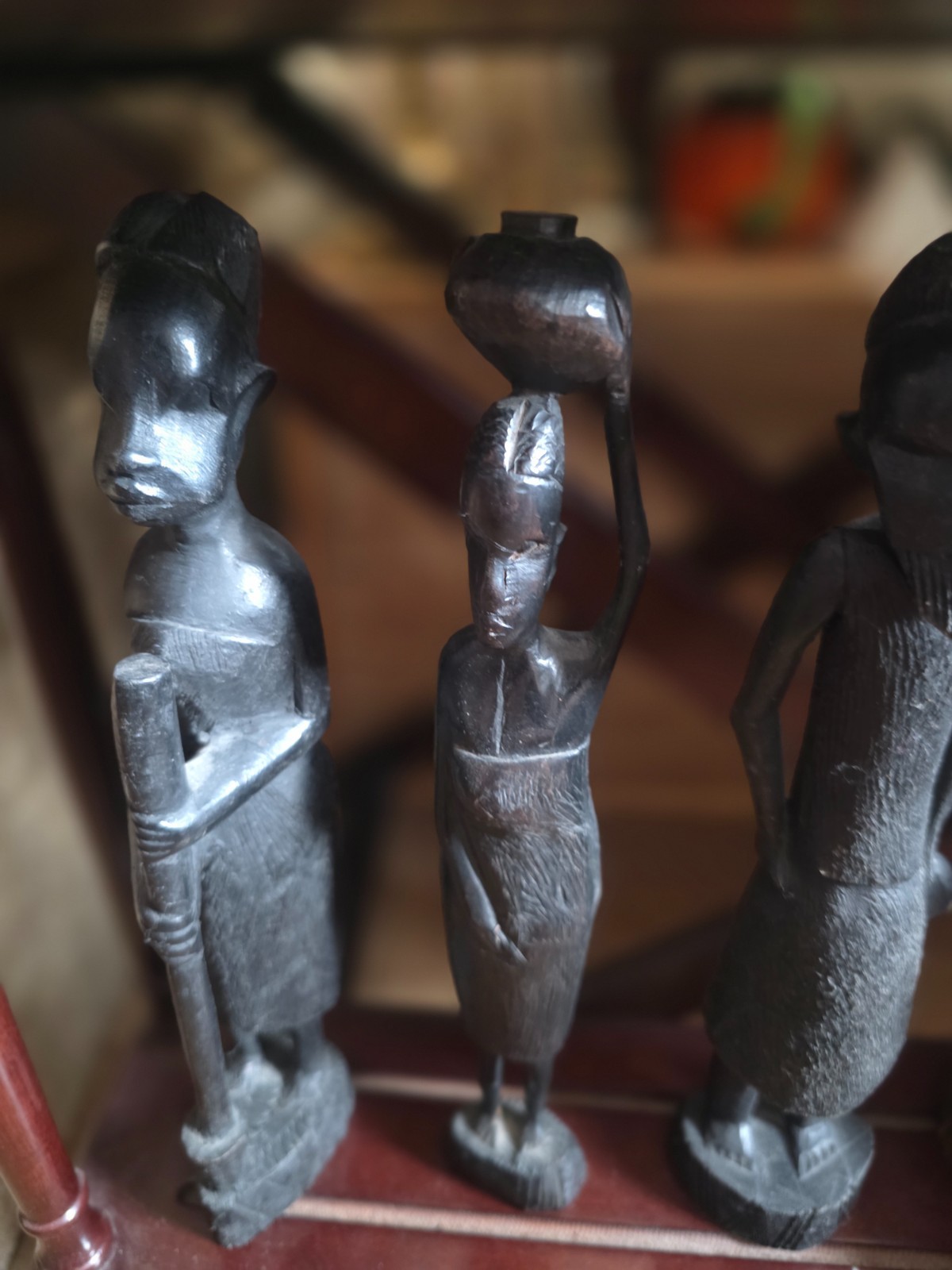 Set of carved statues from black wood, stone, bronze.