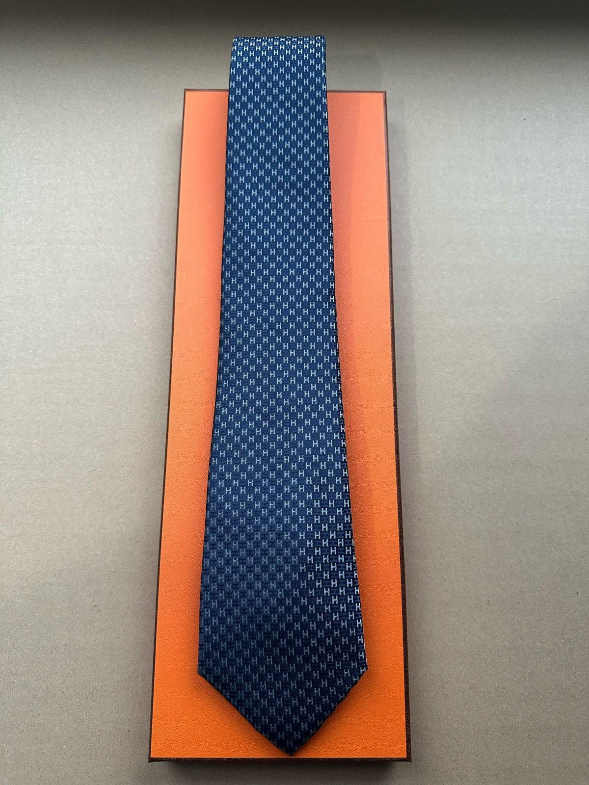 HERMES BLUE SILK TIE -- ALL OVER H MONOGRAM JACQUARD