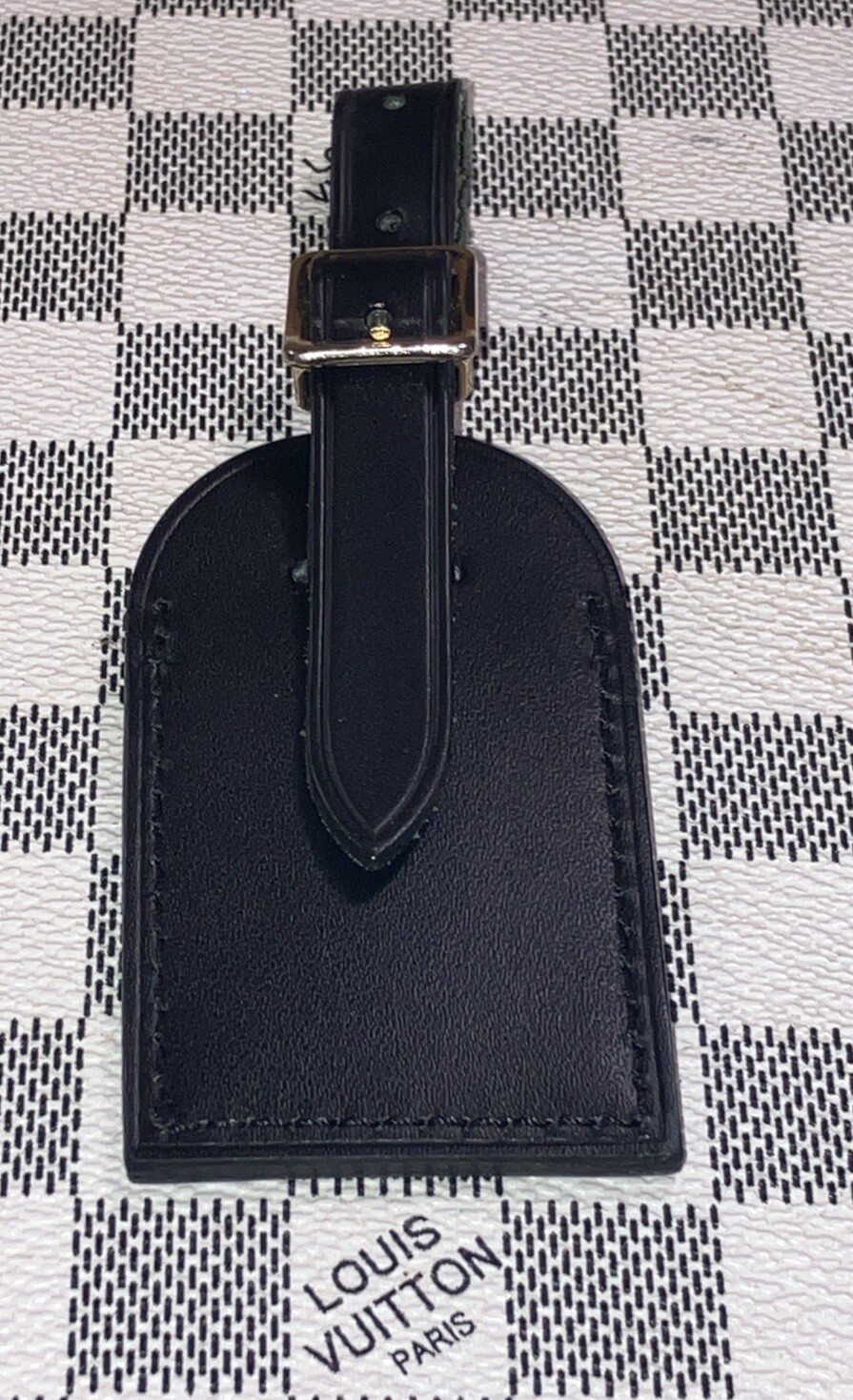 Authentic Louis Vuitton small Black W/ Gold Hardware name tag.