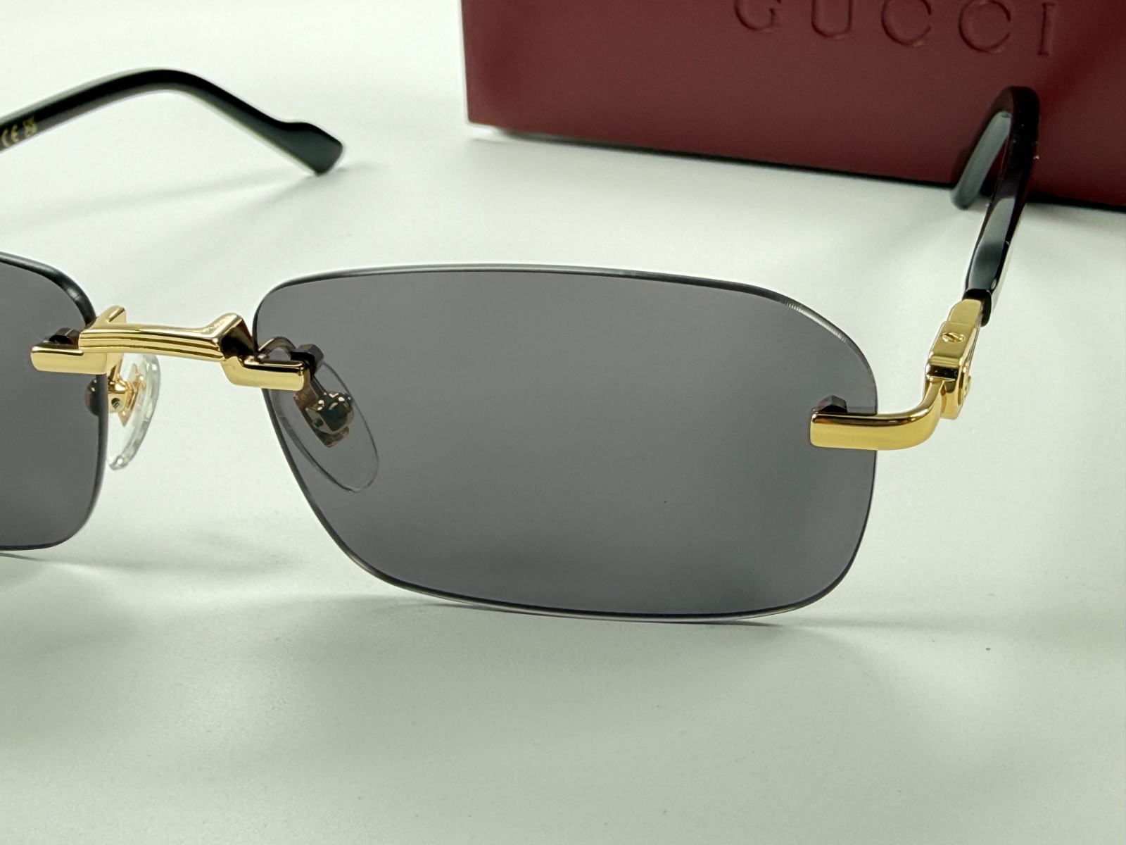 Gucci GG1221S 001 Black Gold Rimless Sunglasses Gray Lens 56mm