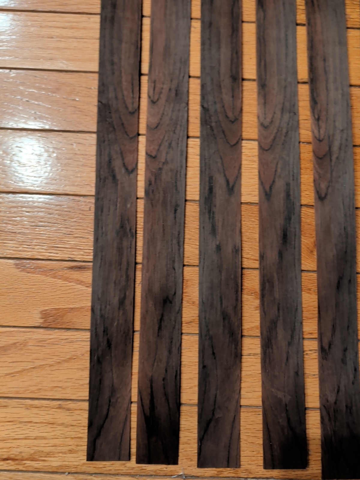 7 pieces of rosewood veneer 1 1/4" to 1 1/2" x 24 1/2" each raw 1/42"