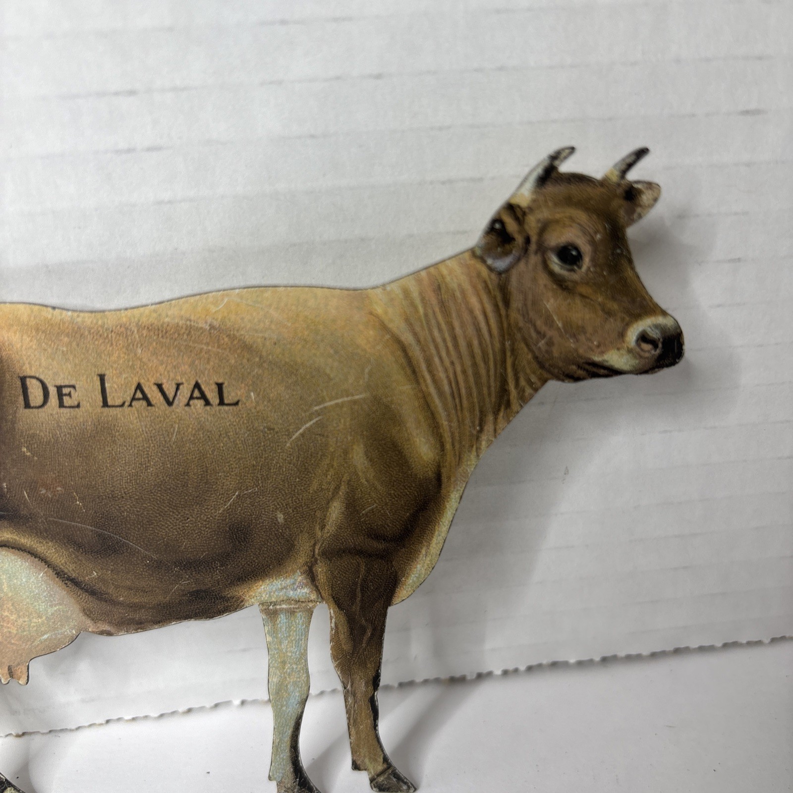 Pair of Antique DeLaval tin die cut cow and calf advertising cream separator ads