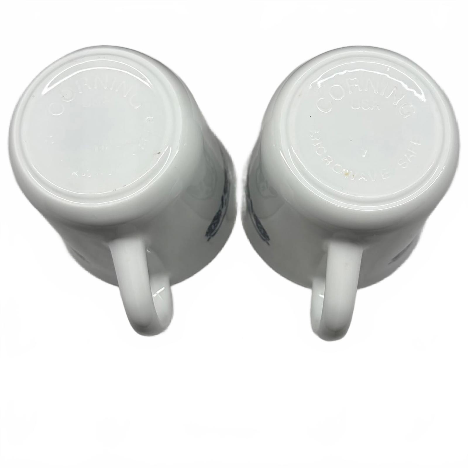 Two white Corning Ware Old Town Blue ceramic mugs with blue floral border.