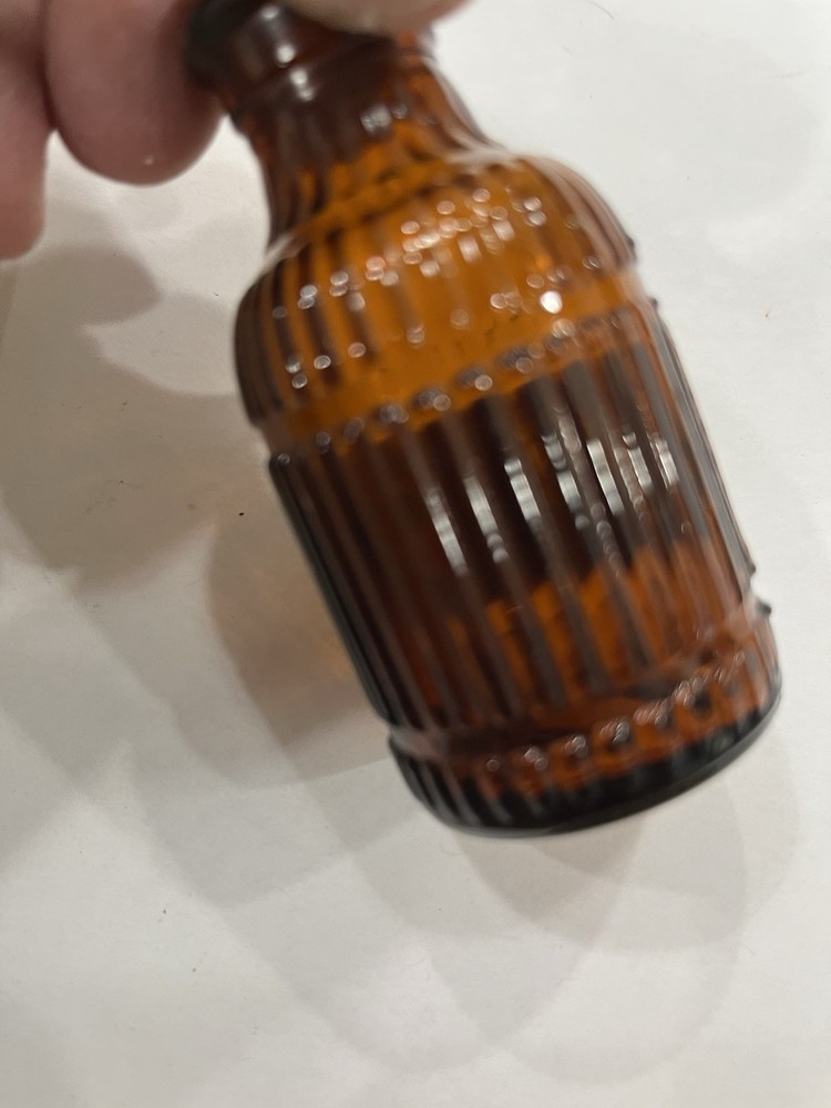 Small Amber Round Ribbed McKESSONS bottle