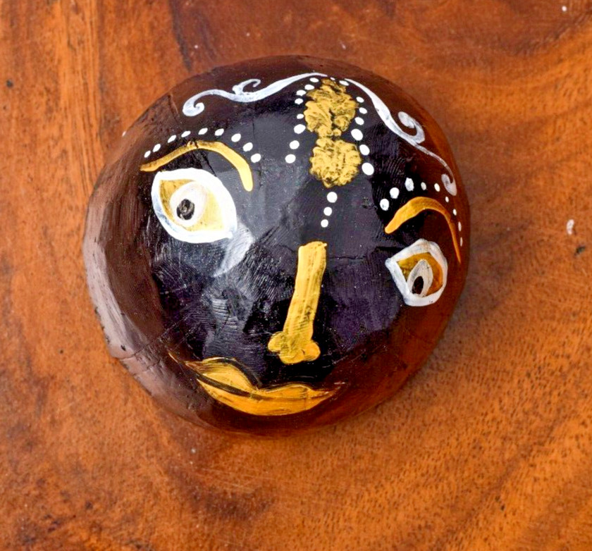 Coconut shells hand painted with different faces specified for hotel decorations