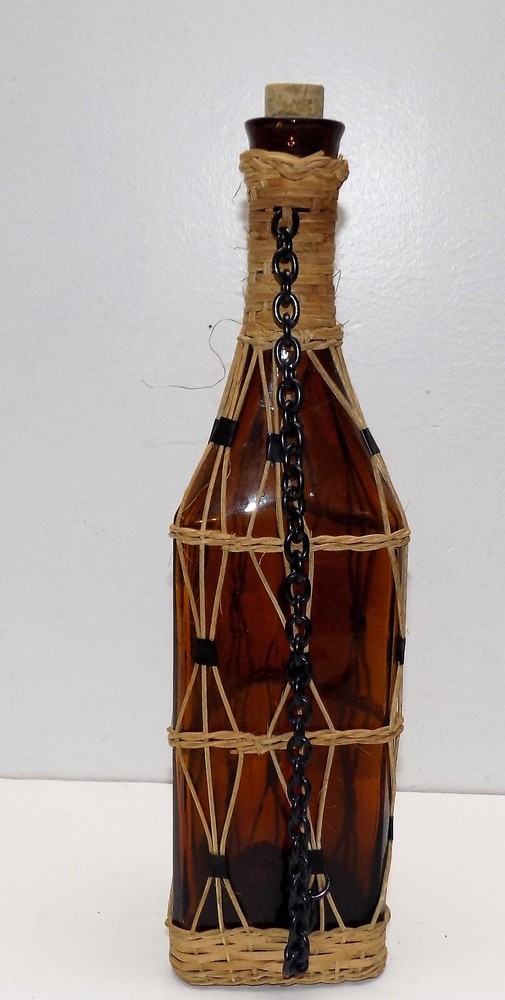 Vintage brown bottle braided with strings.