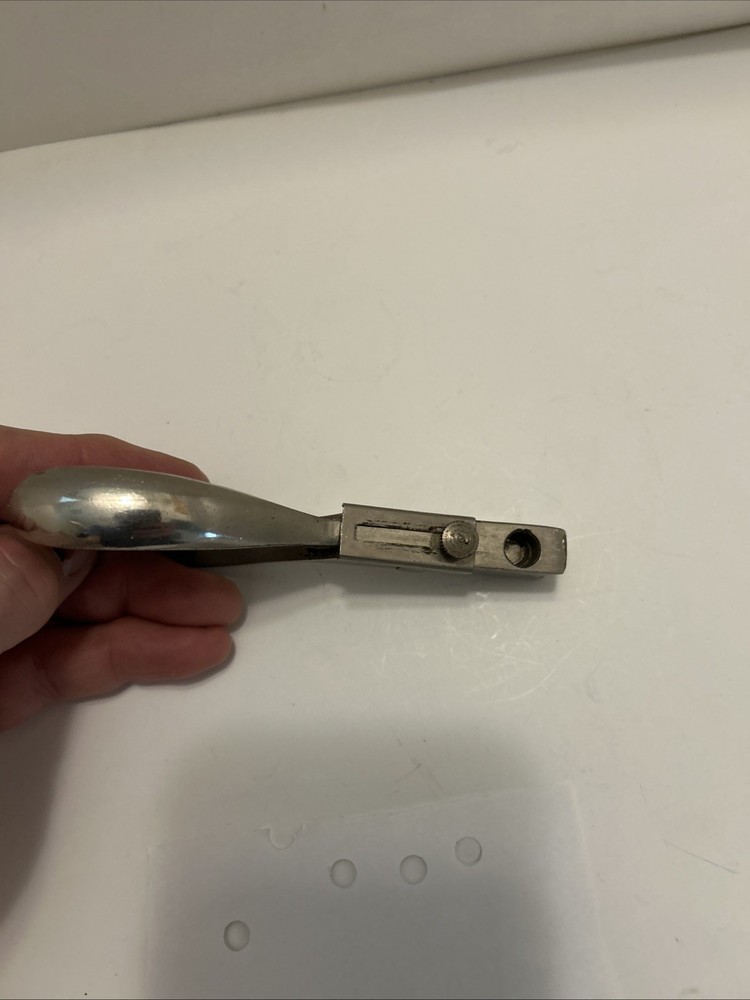 Vintage hole punch with spring handle action and adjustable punch depth guide