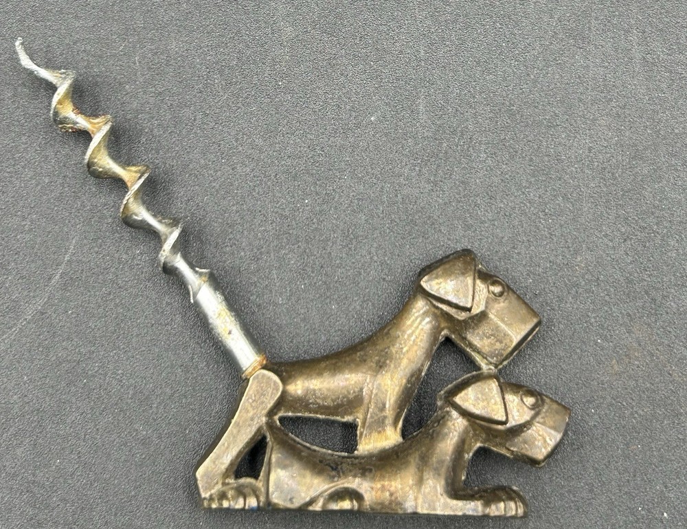 ART DECO CORKSCREW SOLID BRASS DOG. MARKED ENGLAND.