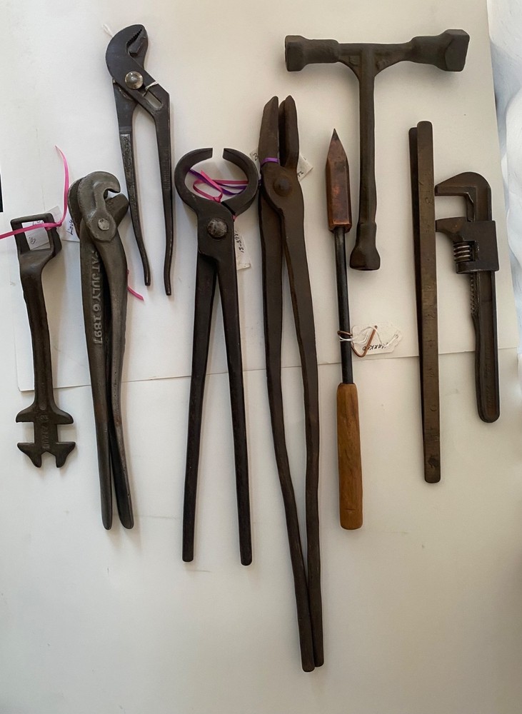 Collection of vintage blacksmithing and farrier tools