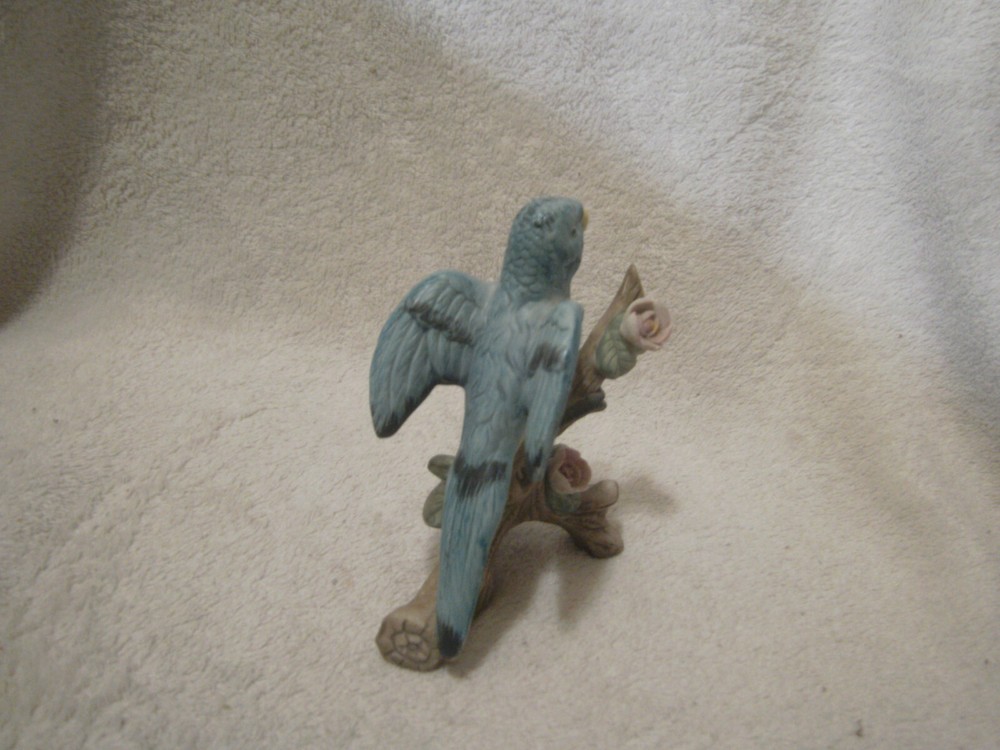 Blue ceramic parrot on tree branch 4 1/2 inches tall