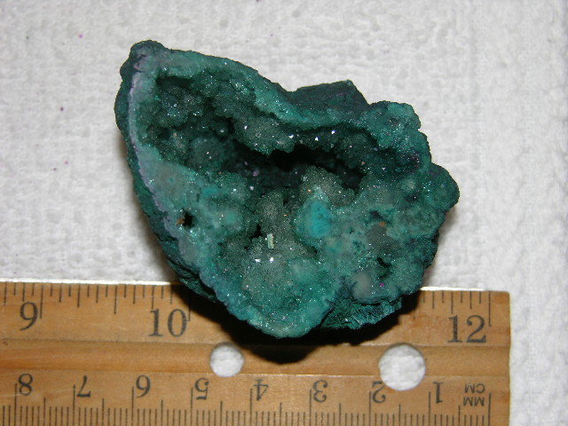 Geode cut & polished half with colored crystal center 2 inch E38