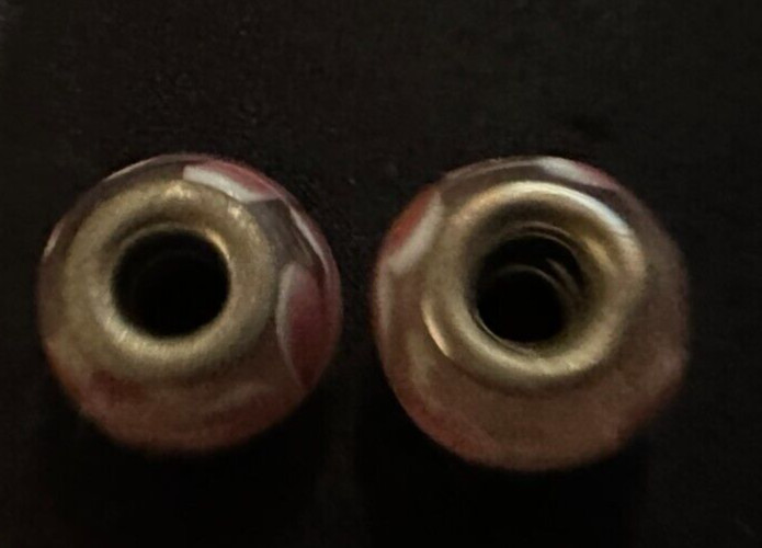 two matching pink patterned charms For Charm Braeclets
