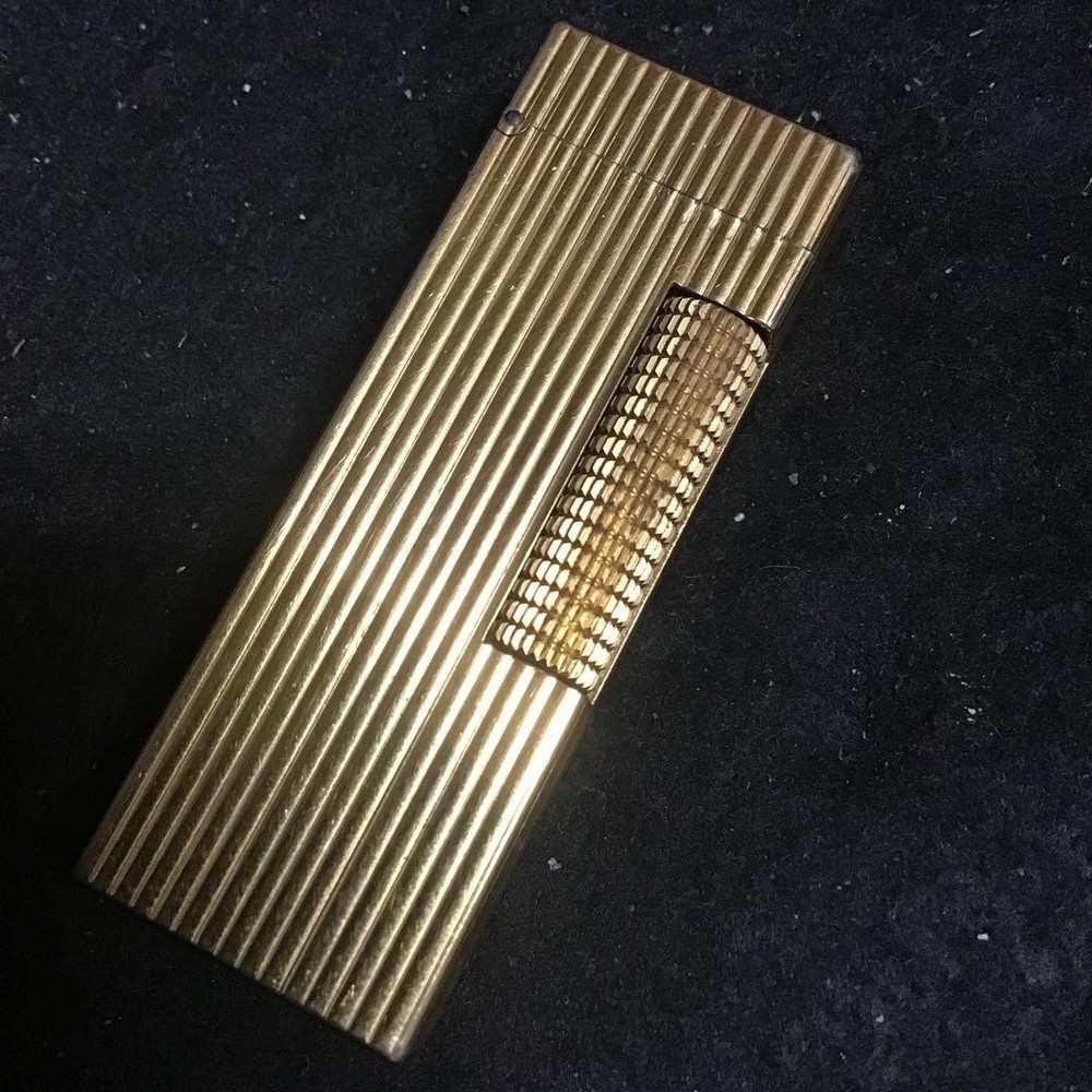 Overhauled gold dunhill lighter with striped pattern, ignition functioning well
