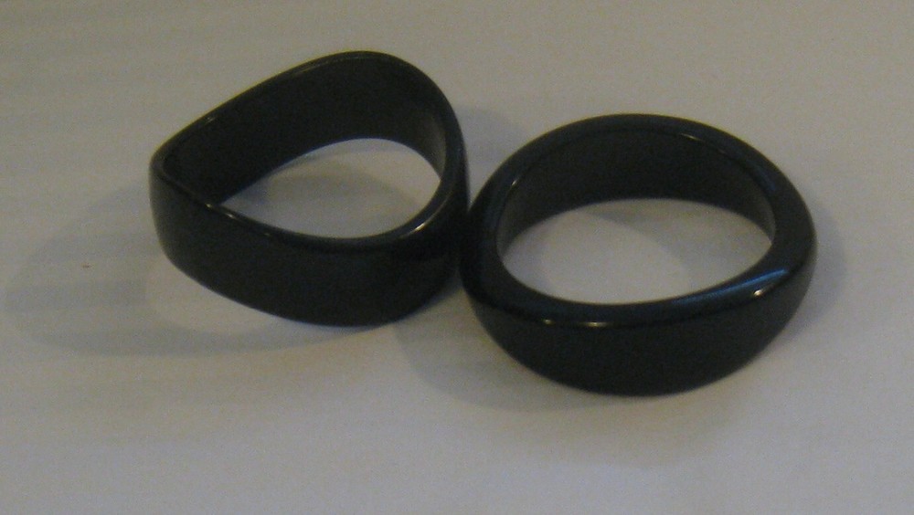 PAIR MID-20TH C. MODERN BLACK TORQUED QUALITY PLASTIC BANGLES: