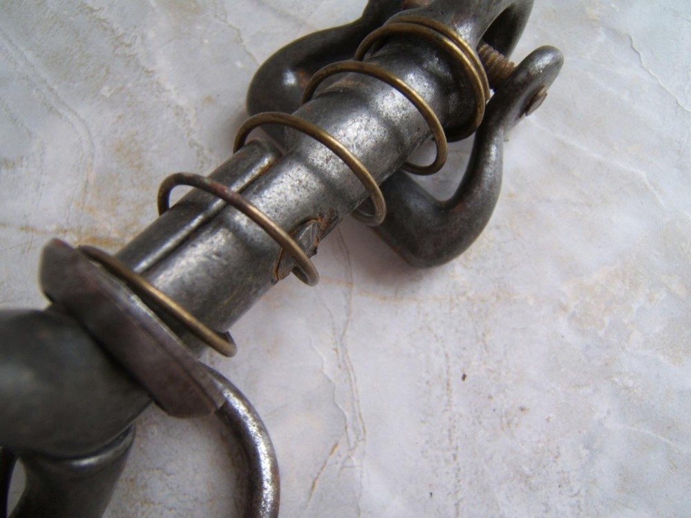 ANTIQUE SPRING-LOADED CAST-IRON BULL LEADING TOOL