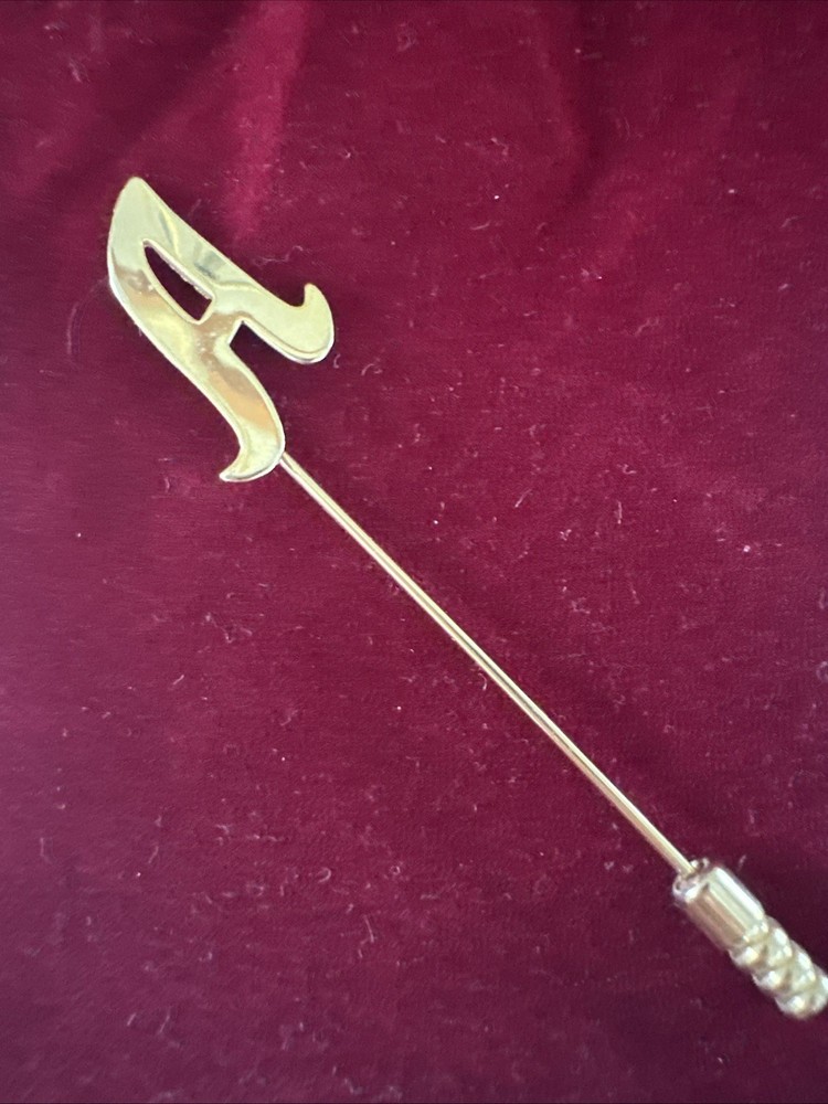 gold-tone monogram lapel pin features a cursive letter 'A' design.
