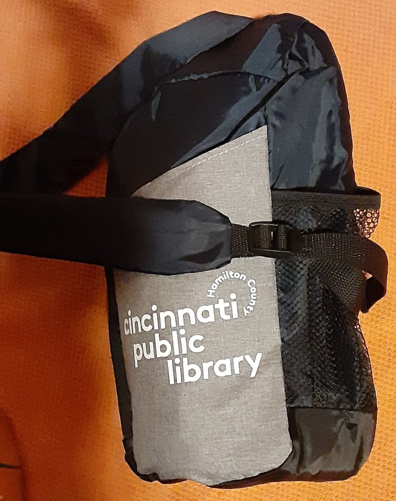 Sling Day Pack, navy blue, Cincinnati Library logo. Roomy, pockets, packable.