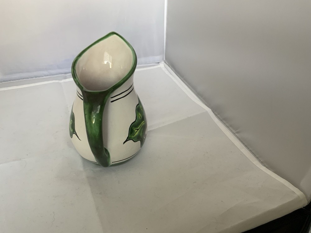 Small ceramic pitcher with floral design Signed