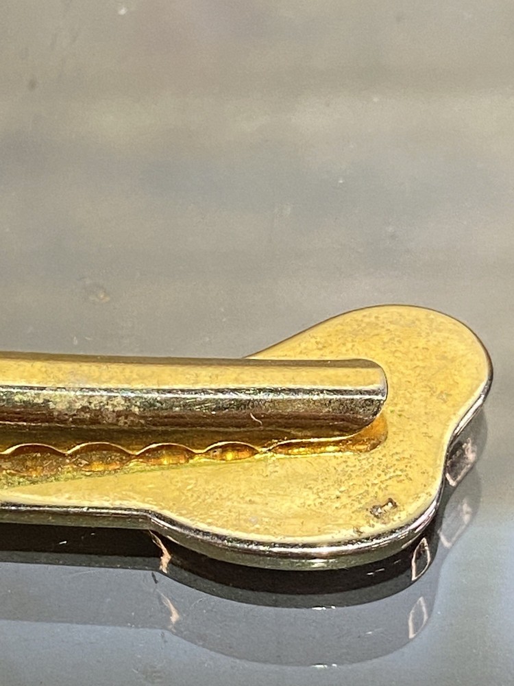 Two Tie Clips, One Marked Anson