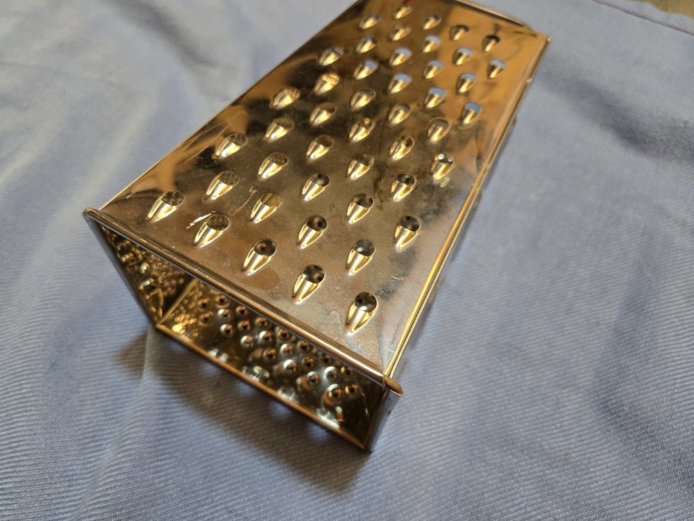 large stainless steel cheese grader