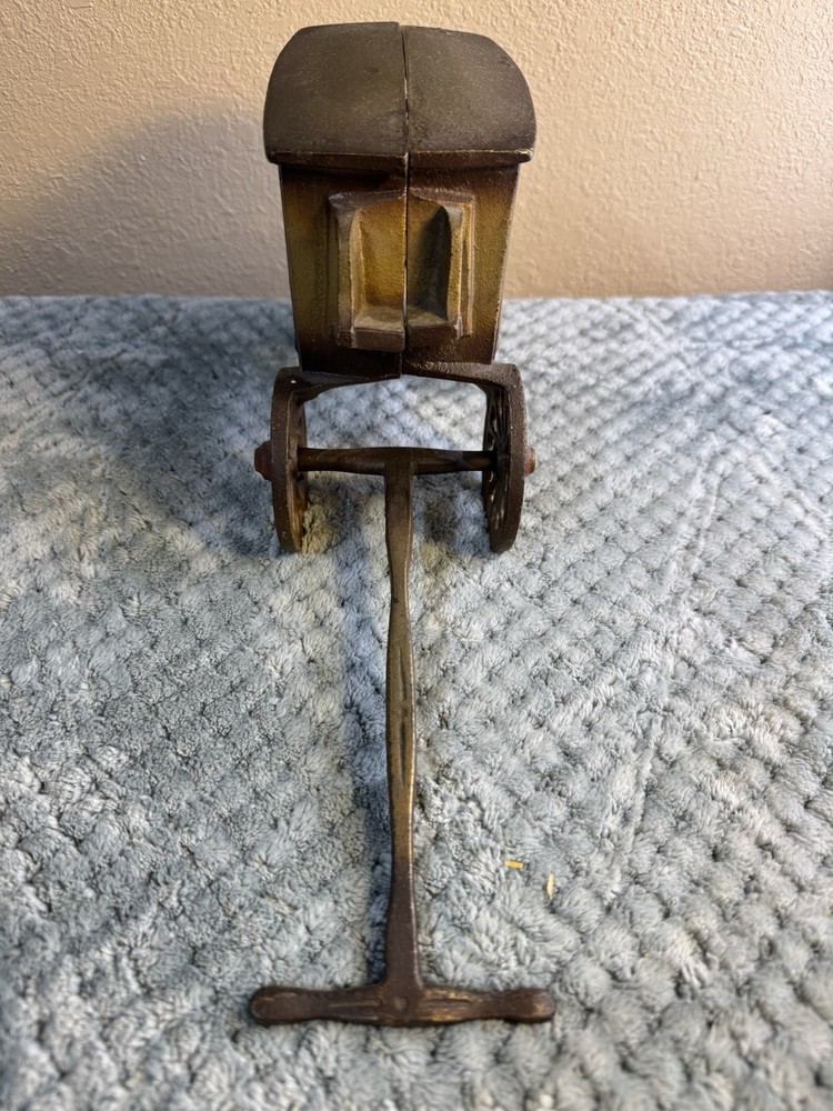 Antique cast iron pull toy carriage with decorative detailing and pull handle