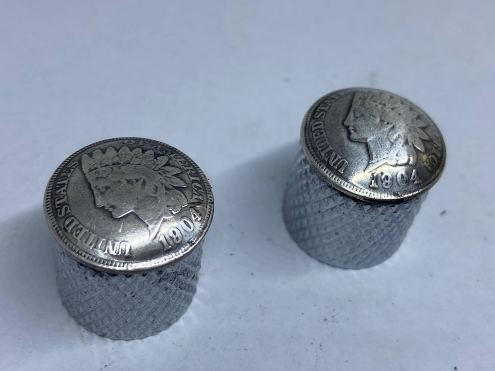 Silver toned Indian penny guitar knobs with knurled sides.