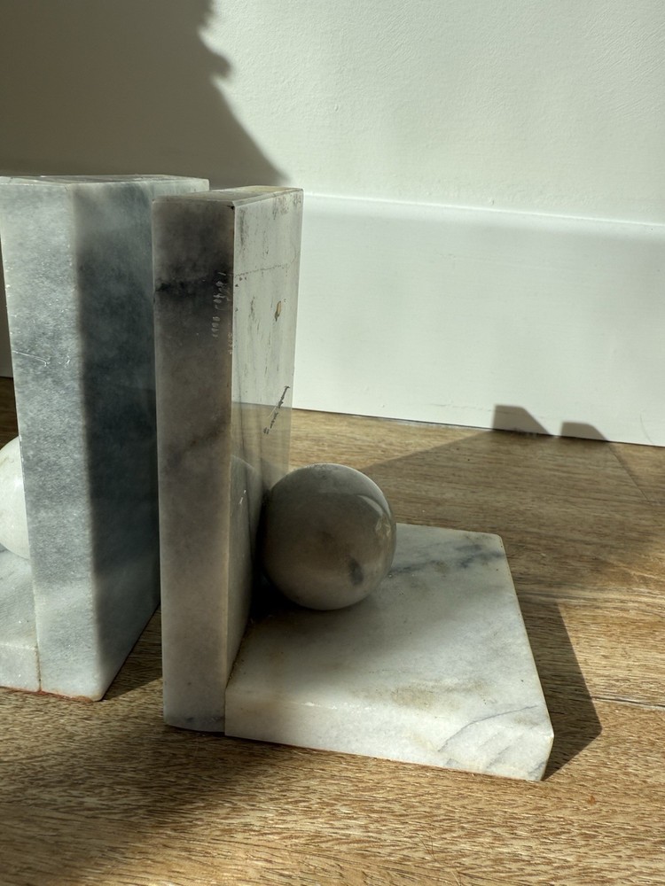 Vintage marble bookends with spherical elements.
