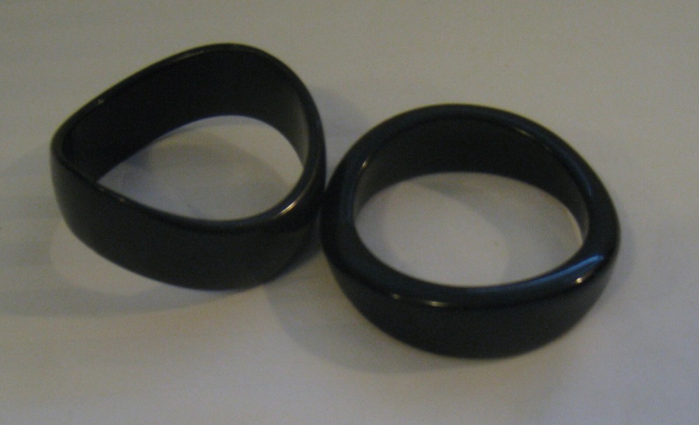 PAIR MID-20TH C. MODERN BLACK TORQUED QUALITY PLASTIC BANGLES: