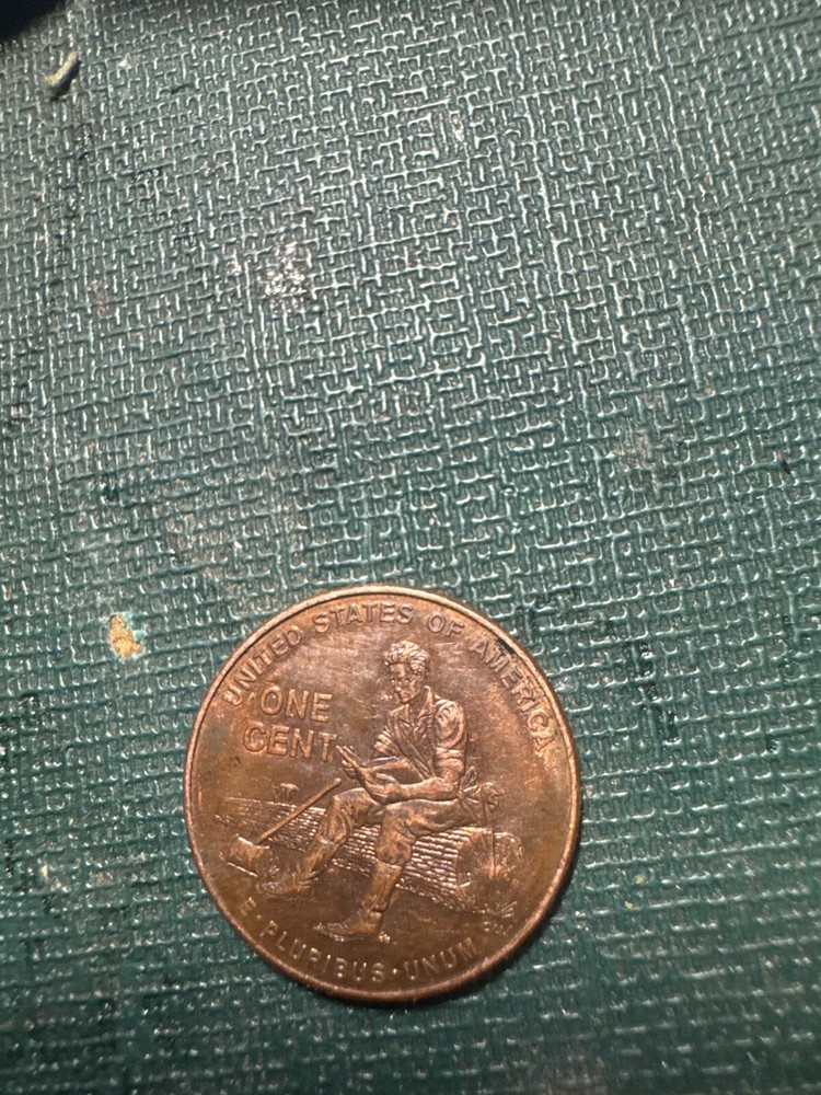 2009 lincoln penny Abe sitting on a log