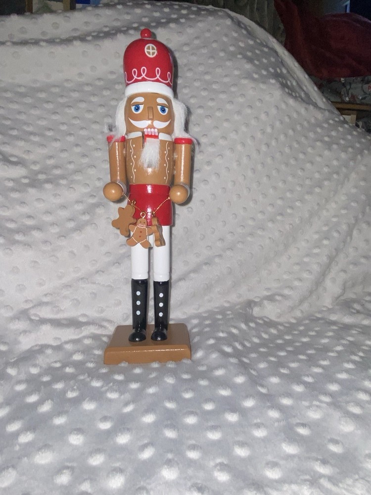 Wood Nutcracker With A String Of Gingerbread Men.