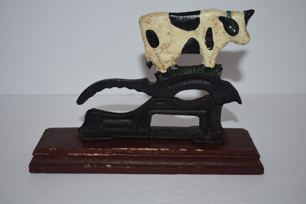 CAST IRON PAINTED COW NUTCRACKER / MOUNTED ON WOODEN BASE - BLACK & WHITE