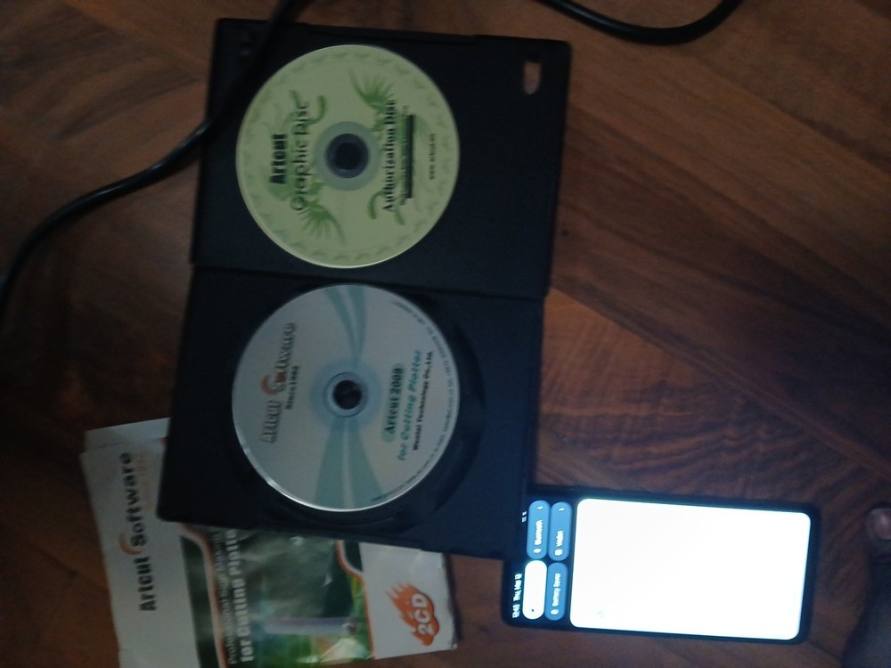 computer-controlled vinyl cutter machine Some Vinyl Material And Two Discs