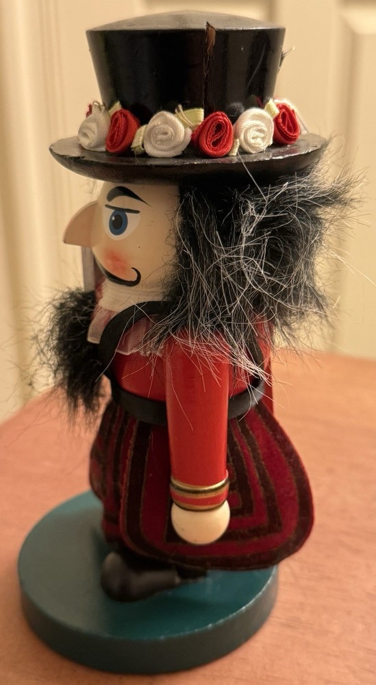 RED STUBBY MULTICOLOR WOODEN NUTCRACKER W/FLOWERED HAT - ENGLISH