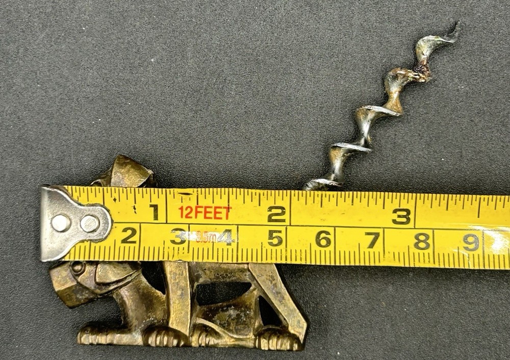 ART DECO CORKSCREW SOLID BRASS DOG. MARKED ENGLAND.