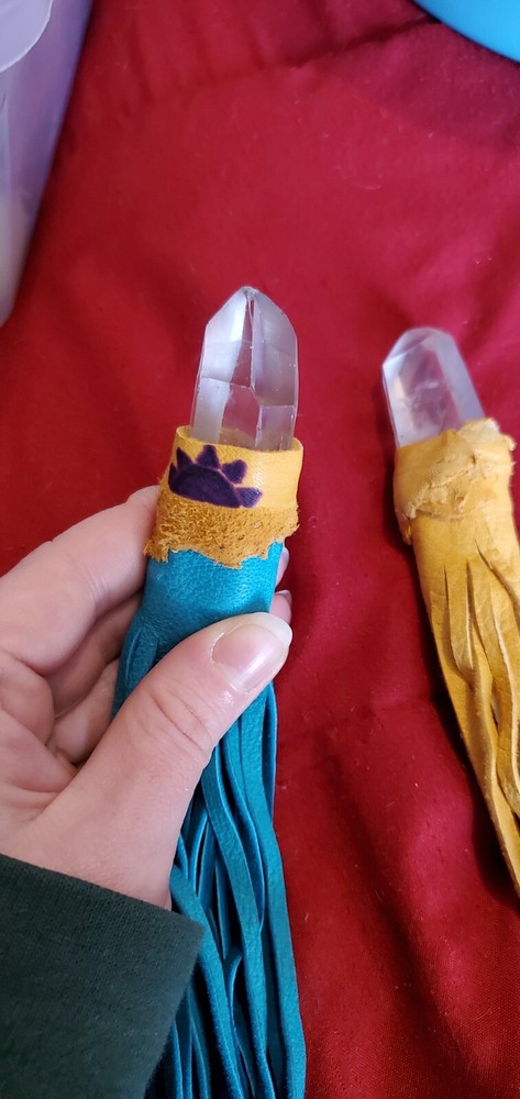 custom made wand tip, quartz with leather strands.