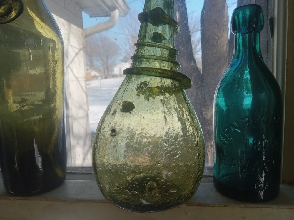 BUBBLY CRUDE HAND BLOWN GLOBULAR SADDLE FLASK BOTTLE WITH DRIPPY APPLIED RING
