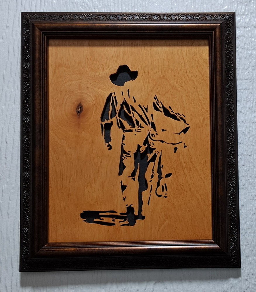 Cowboy with Saddle Handcut scrollsaw, framed, varnished, black backing