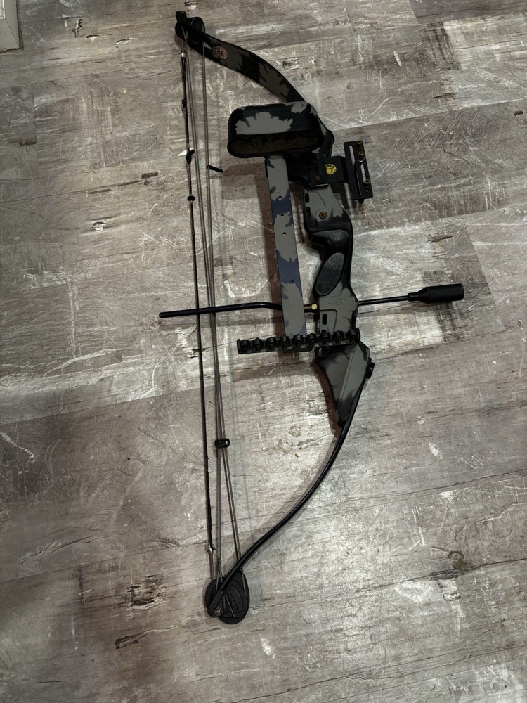 This item is a PSE Polaris Express bow riser, featuring a camouflage design.
