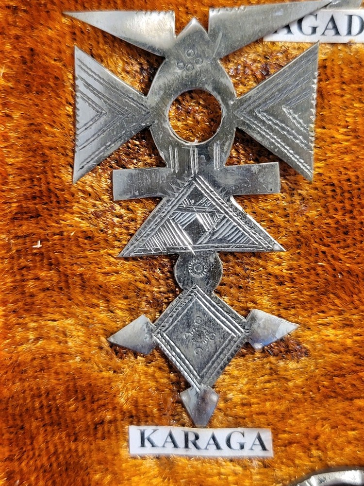 Collection of Hand-tooled Tin Badges