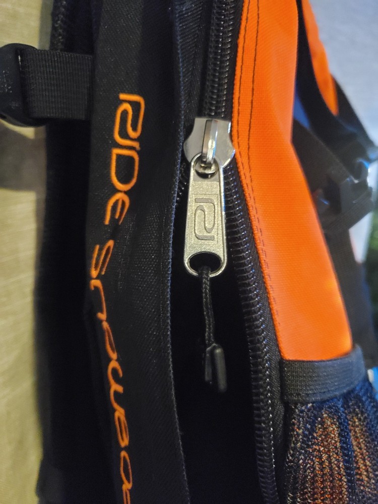 Ride Snowboards: Orange/Black Snowboarding heli-pack backpack