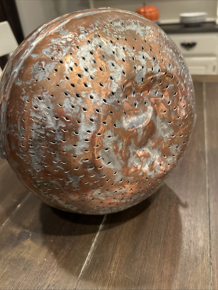Antique Middle Eastern copper lidded storage container with geometric patterns.
