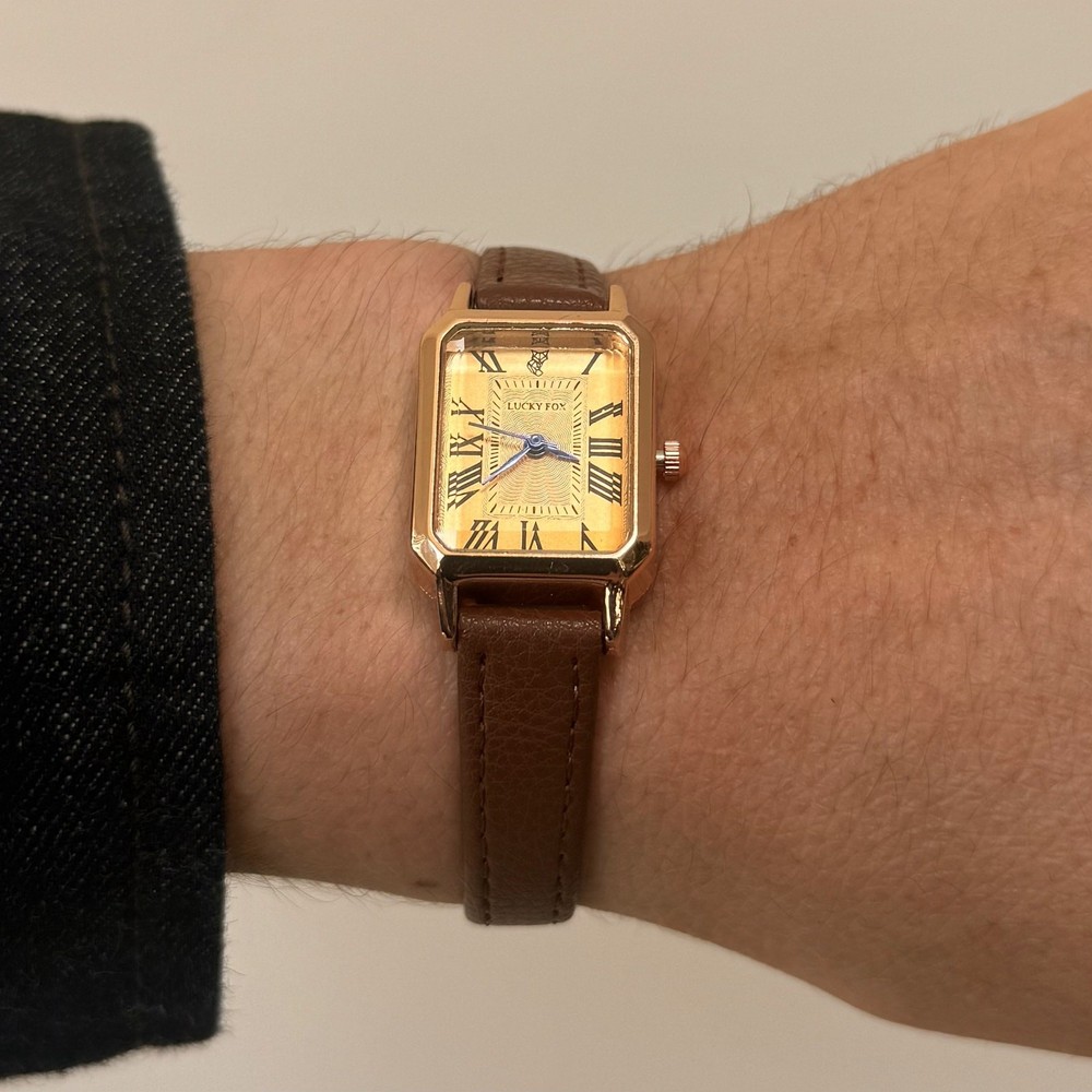 2000s vintage style rectangular gold luxury watch with leather band